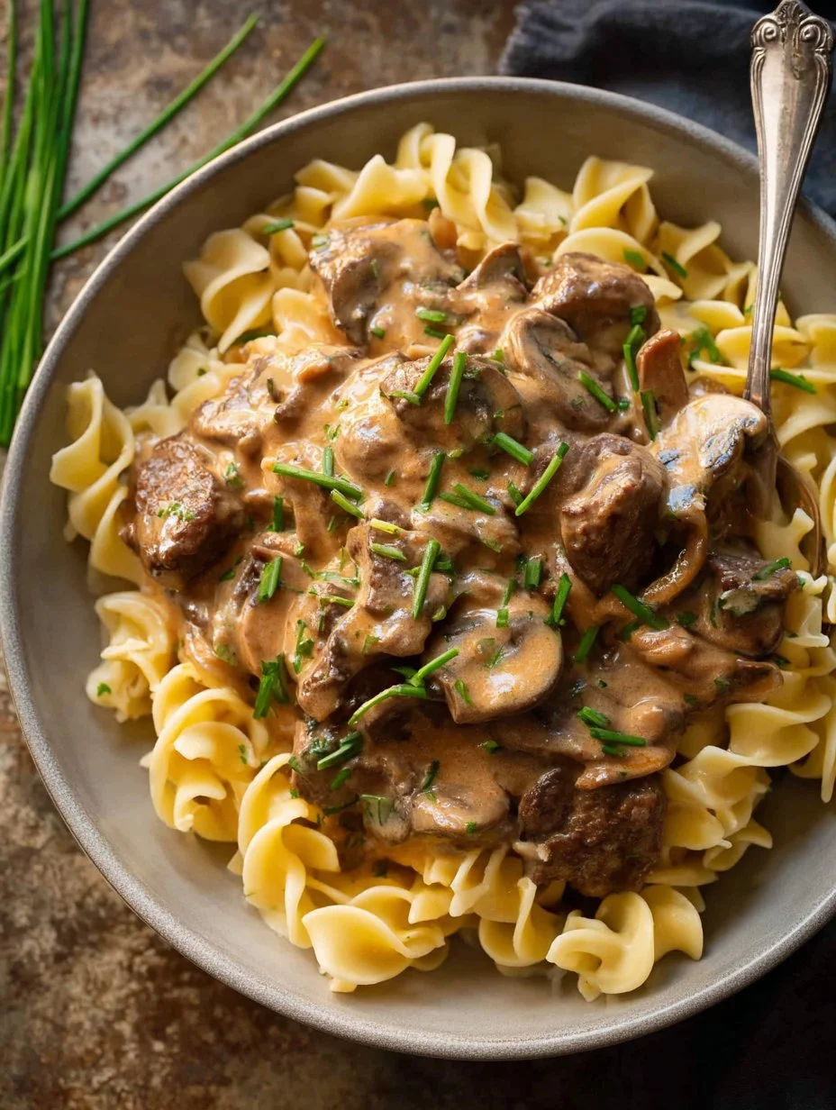 Delicious Beef Stroganoff with tender beef, mushrooms, and creamy sauce served on noodles.