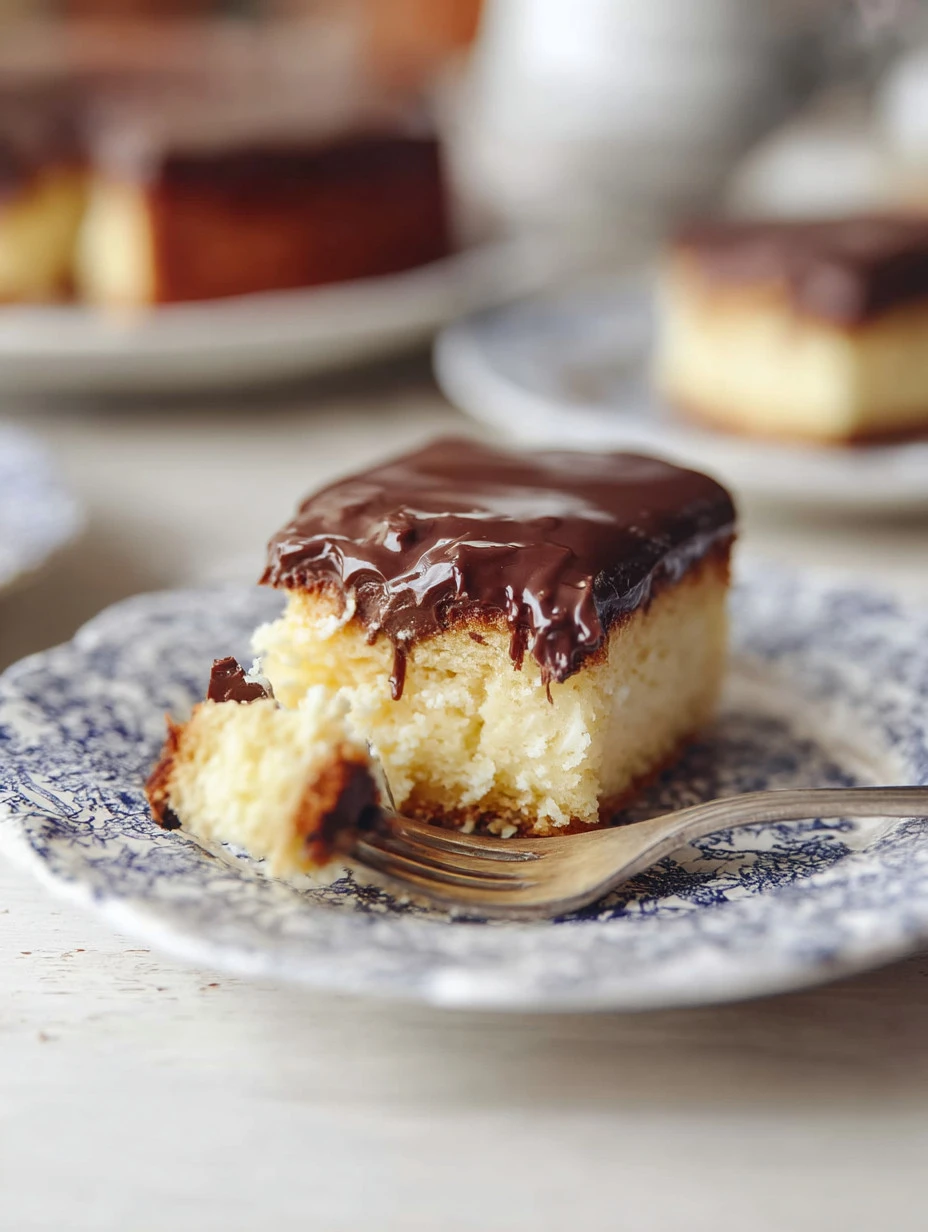 Delicious Boston Cream Poke Cake with chocolate frosting and creamy filling