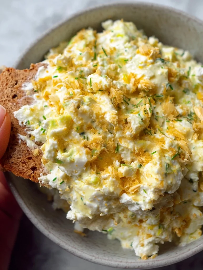 Delicious cottage cheese egg salad served in a bowl with fresh herbs.