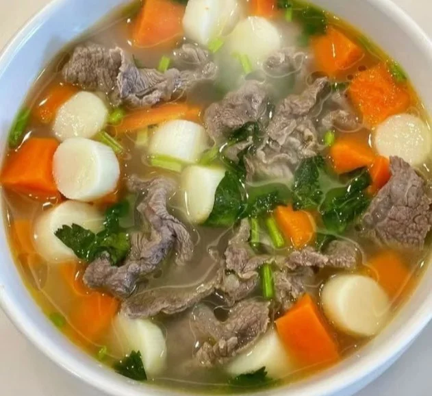 Delicious beef soup with carrots and radish in a bowl