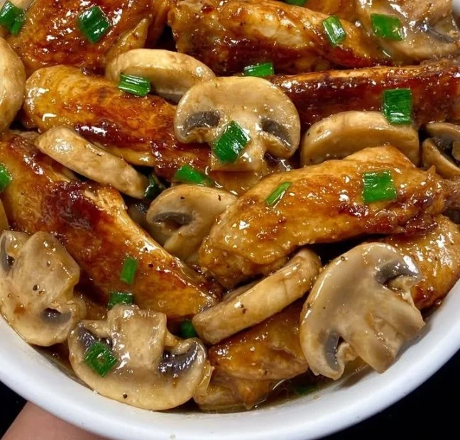 Delicious chicken wings with mushrooms in a savory sauce
