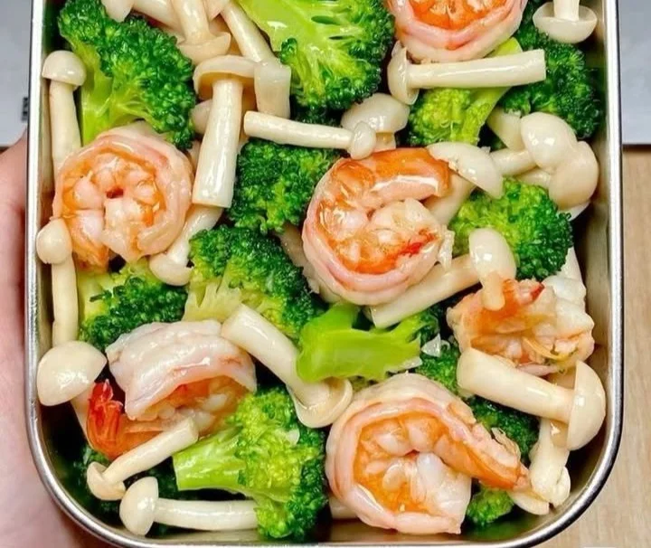 Sautéed shrimp with broccoli and mushrooms served in a bowl