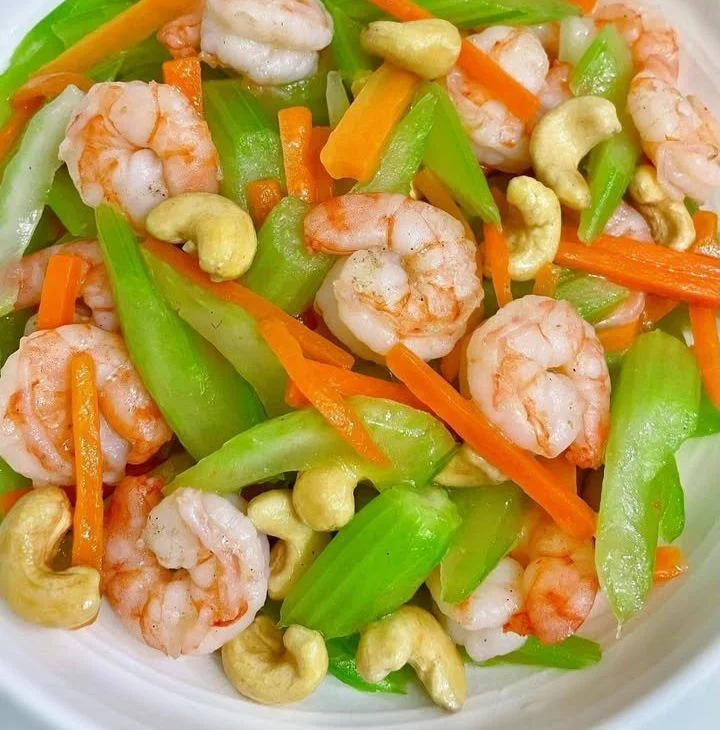 Shrimp stir-fry with celery, carrots, and cashews in a vibrant dish