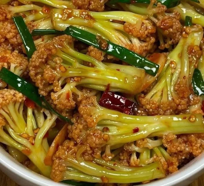 Spicy stir-fried cauliflower served in a vibrant dish with garnishes