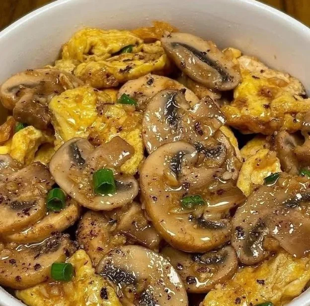 Stir-fried mushrooms and eggs served in a bowl