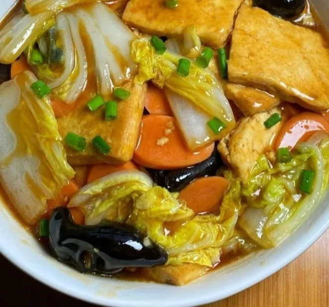 Colorful stir-fried tofu and vegetables dish served in a bowl