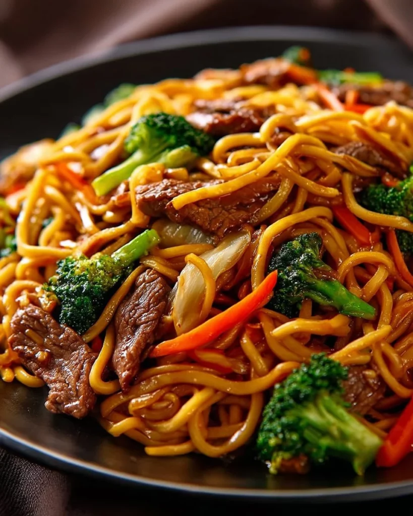 A delicious plate of Beef Lo Mein with noodles, beef, and fresh vegetables.