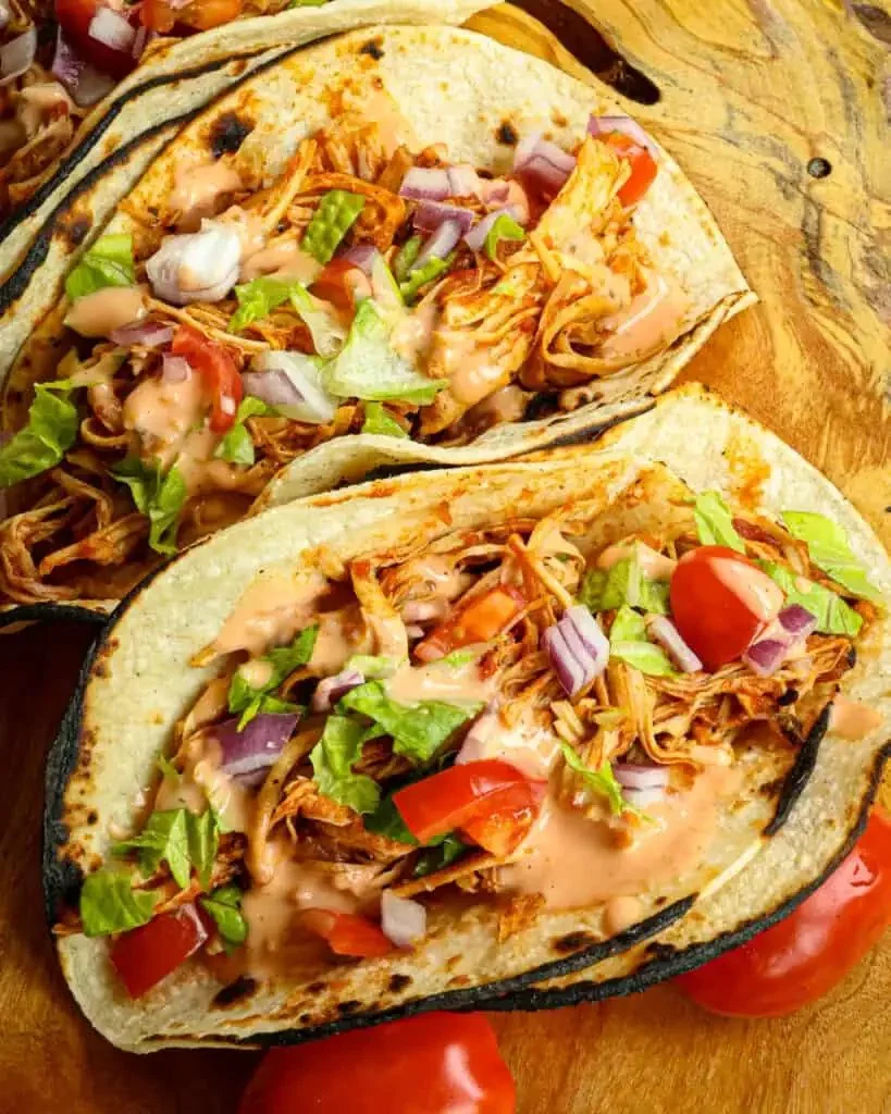 Delicious Crockpot shredded chicken tacos served on a plate with toppings