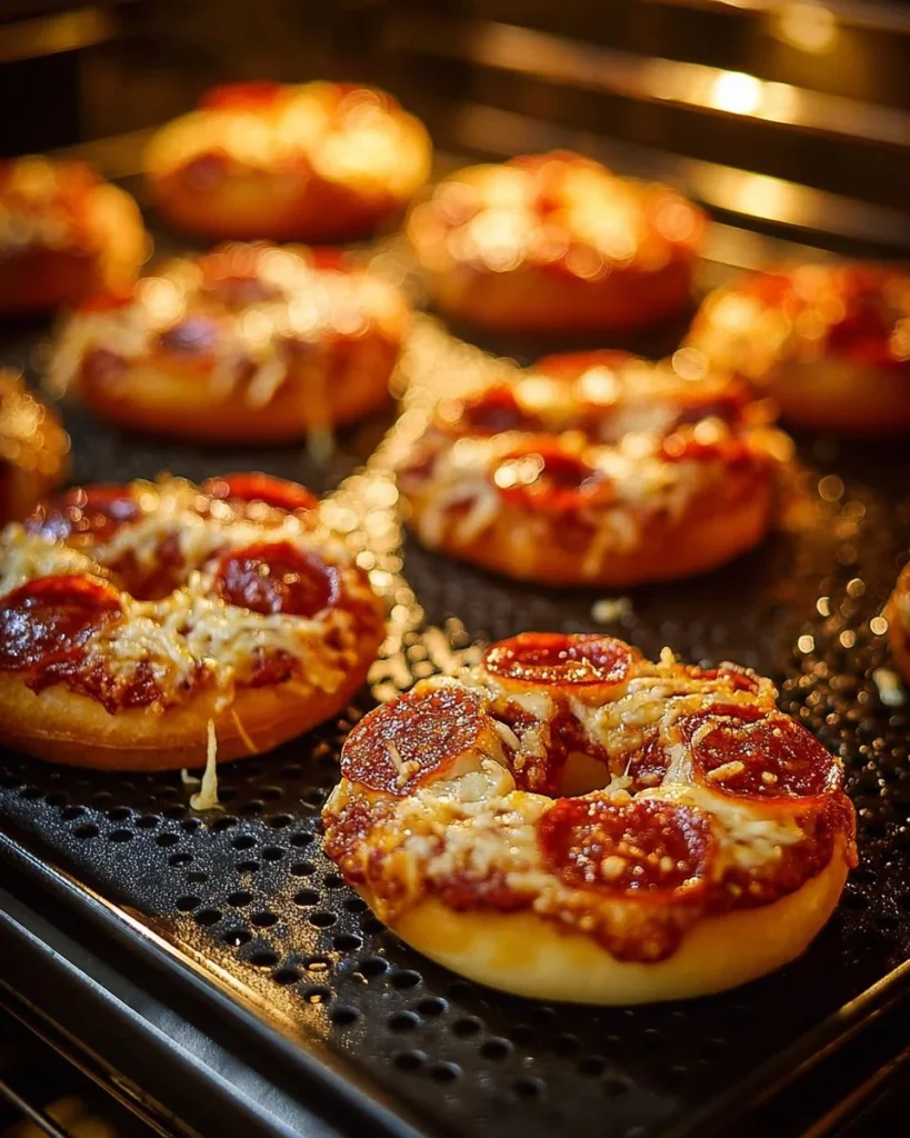 Homemade air fryer pizza bagels with cheese and toppings ready to eat.