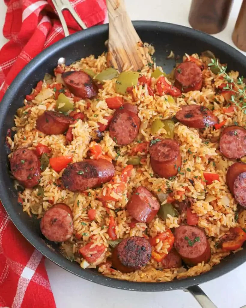 Delicious plate of sausage and rice with colorful vegetables